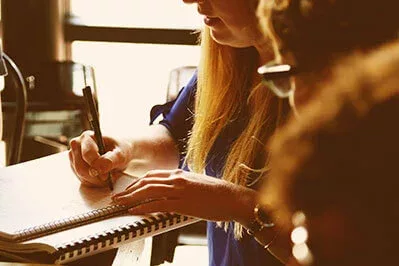 a girl writing down notes